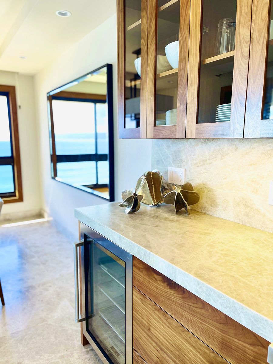 Walnut wet bar with stone counter and ocean view