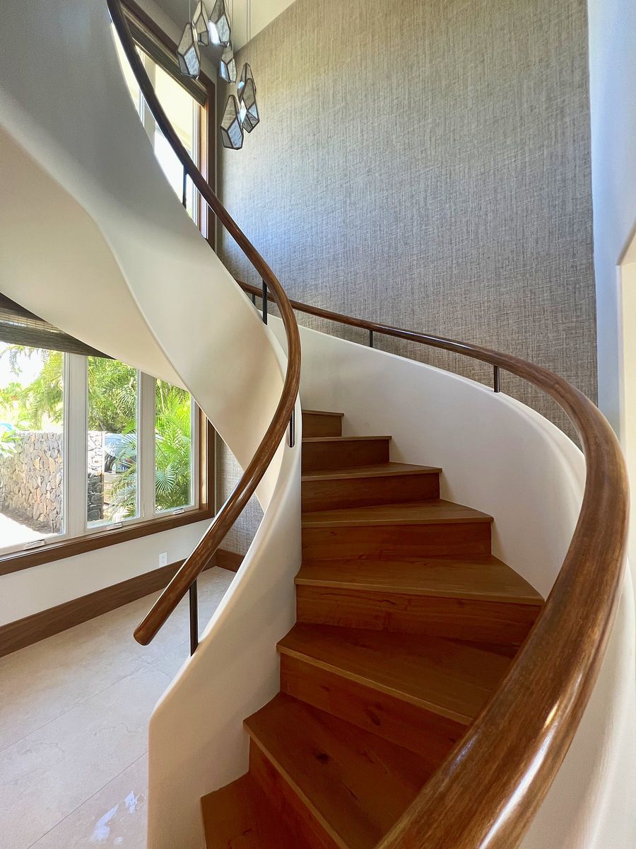 Curved staircase with walnut treads and handrail